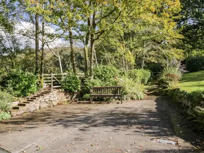 a park bench sitting in the middle of a road at Fell Foot in Holmrook