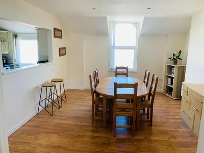 a kitchen and dining room with a table and chairs at Cunard Apartments in Douglas