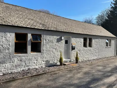a white building with a white door and windows at Terraughtie Cottage East-Uk31767 in Terreglestown