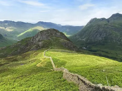 a view of a green mountain with a road at Langdale Cottage in Chapel Stile