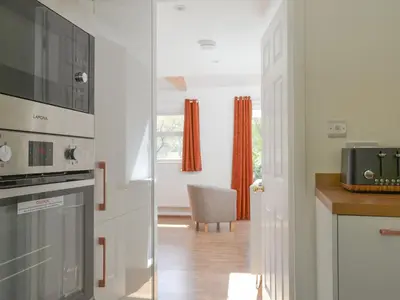 a kitchen with a stove and a microwave at Langdale Cottage in Chapel Stile