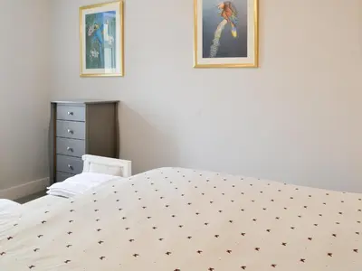 a bedroom with a bed and two pictures on the wall at Old Reading Room in Cotehill