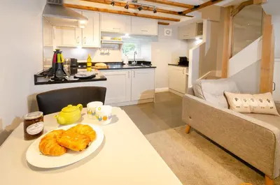 a kitchen with a table with a plate of food on it at Cherry Tree Cottage in Chapel Stile