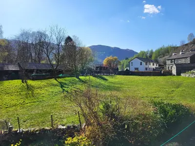 a field of green grass with a house in the background at Meadow View Chapel Stile in Chapel Stile