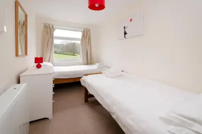 a room with two beds and a window at 27 Thrang Brow, Chapel Stile in Chapel Stile