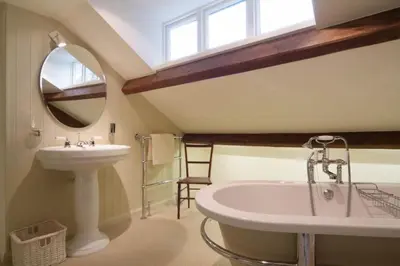 a bathroom with a sink and a mirror at Barnhowe, Elterwater in Chapel Stile