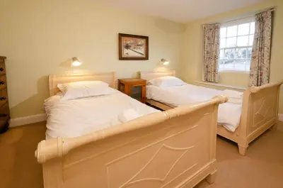 a bedroom with two beds and a window at Beck Steps, Elterwater in Chapel Stile