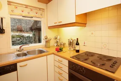 a kitchen with a sink and a stove top oven at Church Bank in Chapel Stile