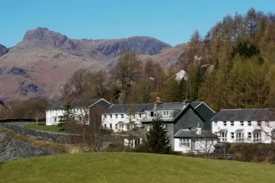 a house on a hill with mountains in the background at Lingmell Fell View, Chapel Stile in Chapel Stile