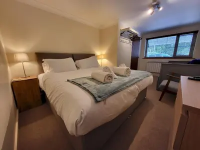 a bedroom with a large bed with towels on it at Lingmell Fell View, Chapel Stile in Chapel Stile