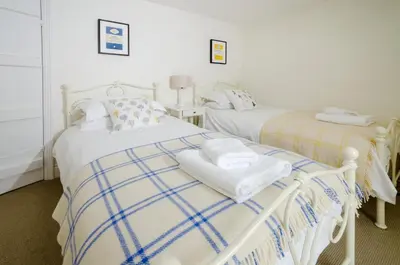 a bedroom with two beds with towels on them at Priest End, Chapel Stile in Chapel Stile