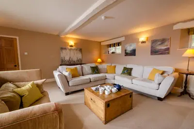 a living room with couches and a coffee table at The Eltermere Old Barn, Elterwater in Elterwater