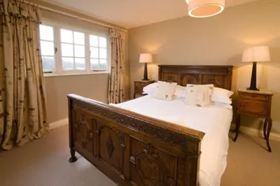 a bedroom with a large bed and a window at The Eltermere Old Barn, Elterwater in Elterwater