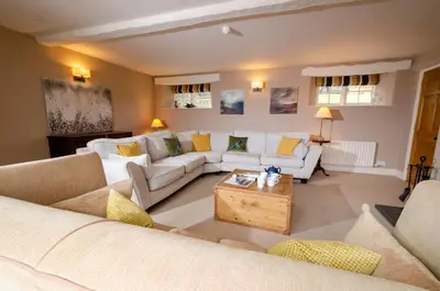 a living room with couches and a coffee table at The Eltermere Old Barn, Elterwater in Elterwater