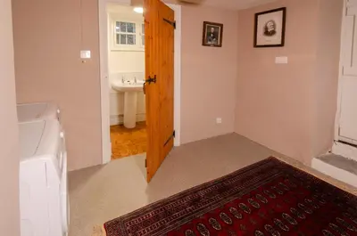 a bathroom with a tub and a sink and a door at The Old White Lion, Chapel Stile in Chapel Stile