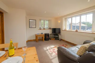 a living room with a couch and a table at The Stables, Elterwater in Elterwater