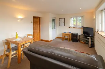 a living room with a couch and a table at The Stables, Elterwater in Elterwater