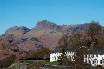 a white house in front of a mountain at Underthrang, Chapel Stile in Chapel Stile