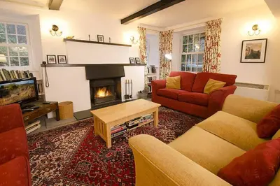 a living room with two couches and a fireplace at Woodland Crag Cottage, Grasmere in Grasmere