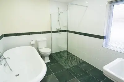 a bathroom with a toilet and a glass shower at Lang Parrock, Little Langdale in Little Langdale