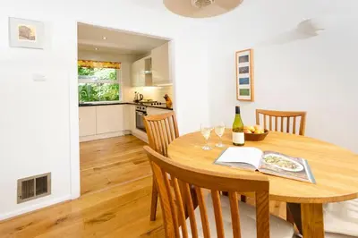 a kitchen and dining room with a wooden table and chairs at Jadians Nook, 16 Thrang Brow in Chapel Stile