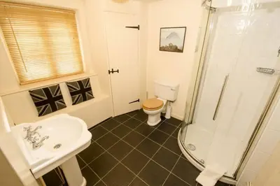 a bathroom with a toilet and a sink and a shower at Juniper Grasmere - Juniper Cottage, Grasmere in Grasmere