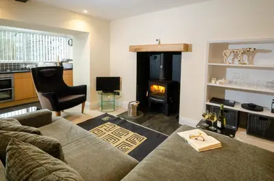 a living room with a couch and a fire place at Anns Cottage, Chapel Stile in Chapel Stile