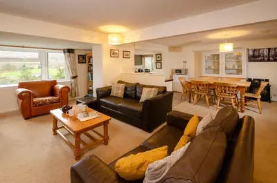 a living room with a couch and a table at Langdale Hideaway in Chapel Stile