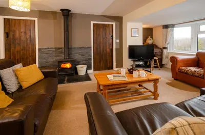 a living room with a couch and a fireplace at Langdale Hideaway in Chapel Stile