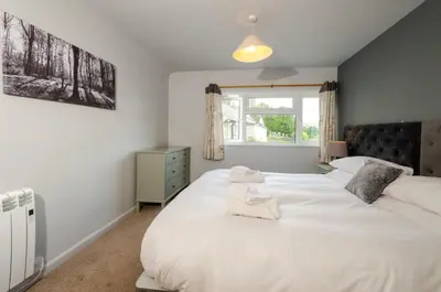 a bedroom with two white beds and a window at Langdale Hideaway in Chapel Stile
