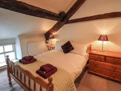 a bedroom with a large bed with two pillows on it at Blease Garth in Threlkeld