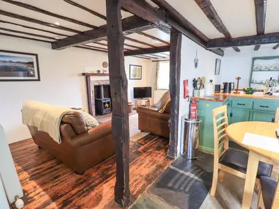 a living room with a couch and a table at Blease Garth in Threlkeld