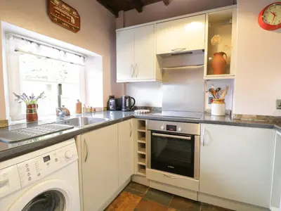 a kitchen with a sink and a dishwasher at Beckside Cottage in Welton