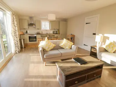 a living room with a couch and a table at Ardlochan Lodge - Culzean Castle in Maybole