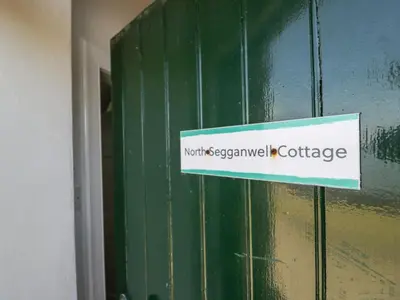 a sign on the side of a green door at North Segganwell - Culzean Castle in Maybole