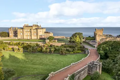 an aerial view of a castle with a road in front at Royal Artillery Cottage - Culzean Castle in Maybole