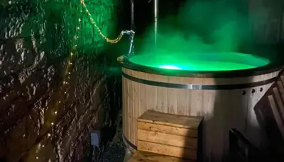 a barrel with a green water inside of it at 2-Bed Barn Hot Tub & Pet Friendly near Muirkirk in Cumnock
