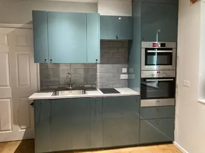 a kitchen with blue cabinets and a sink at The Annex in Carlisle