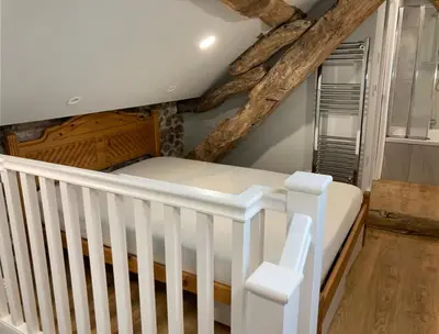 a white crib in a room with wooden floors at The Annex in Carlisle