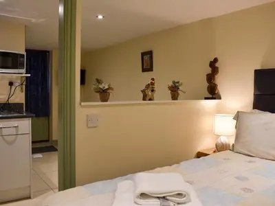 a bedroom with a bed and some plants on a shelf at Danika East in Threlkeld