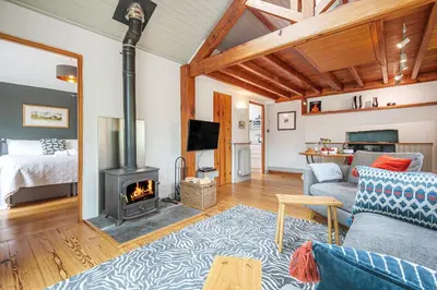 a living room with a couch and a fireplace at The Stable At Oakbank in Elterwater