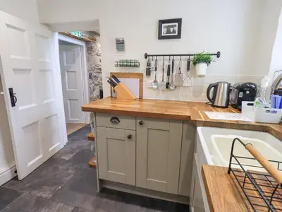 a kitchen with a counter top and a sink at Yew Tree Cottage Borrowdale in Rosthwaite