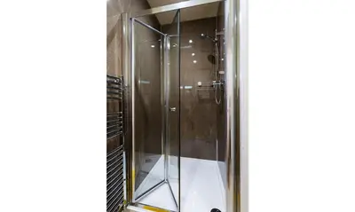 a shower in a bathroom with a glass door at Dovedale in Keswick