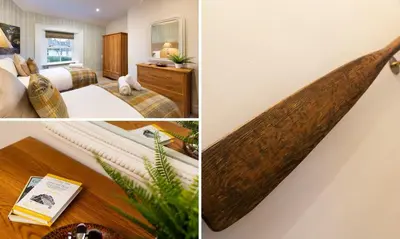 a surfboard hanging on the wall of a hotel room at Crow Cottage in Keswick