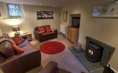 a living room with a couch and a fireplace at Townfoot Cottage in Elterwater