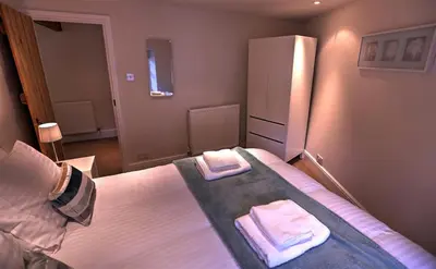 a bedroom with a bed with two towels on it at Townfoot Cottage in Elterwater