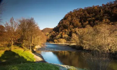a river in the middle of a mountain with trees at Grange Fell Borrowdale in Keswick