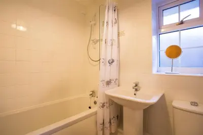 a bathroom with a sink and a shower curtain at Grange Fell Borrowdale in Keswick