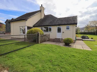 a house with a fence in front of a yard at Laal Field House in Keswick