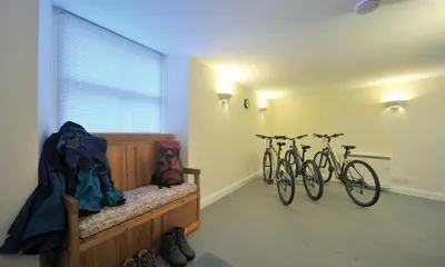 two bikes parked in a room with a bedroom at Low Croft Cottage in Grasmere